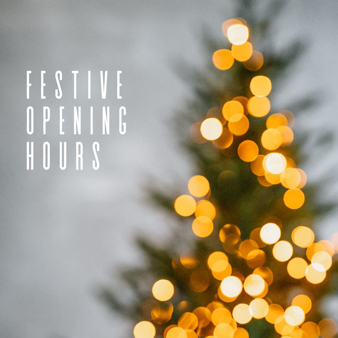 Christmas tree blurred in background with white overlay text reading festive opening hours